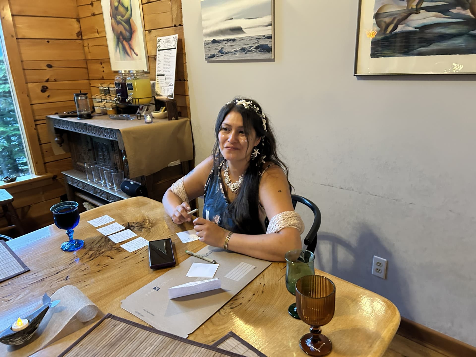 A Wild N Well guest writing and creating at the cabin table