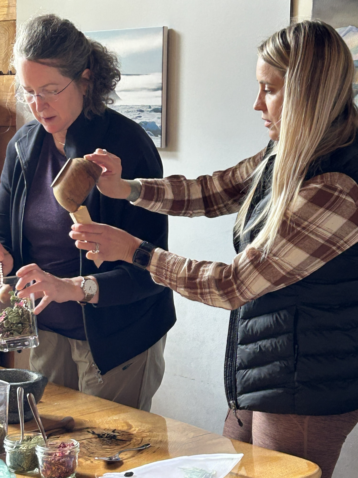 Guests pouring tea during a hands-on Wild N Well experience