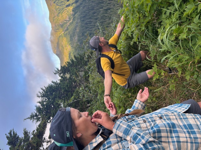 Friends tasting wild berries on a mountain trail