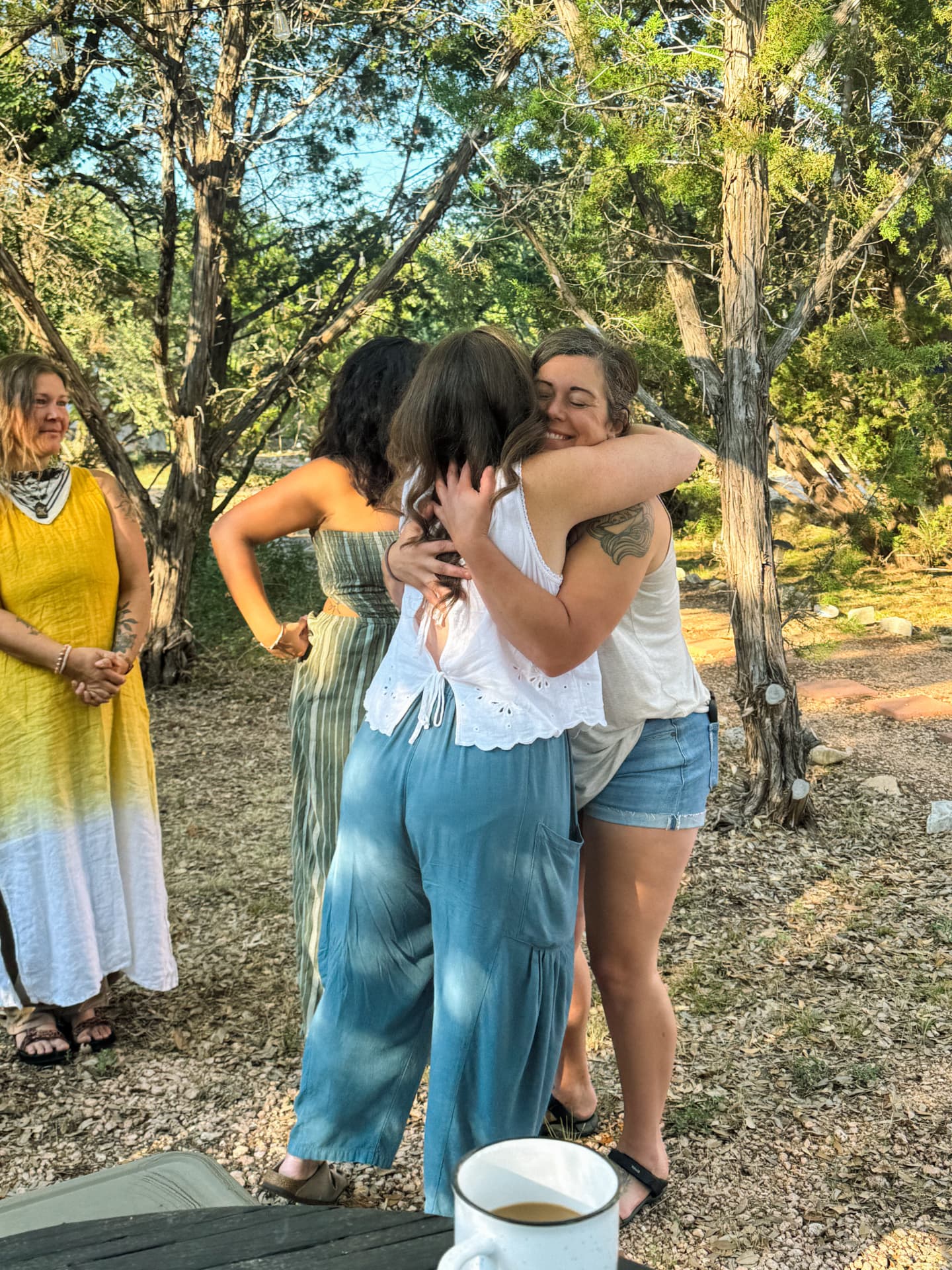 Women embracing outdoors after sharing a retreat experience