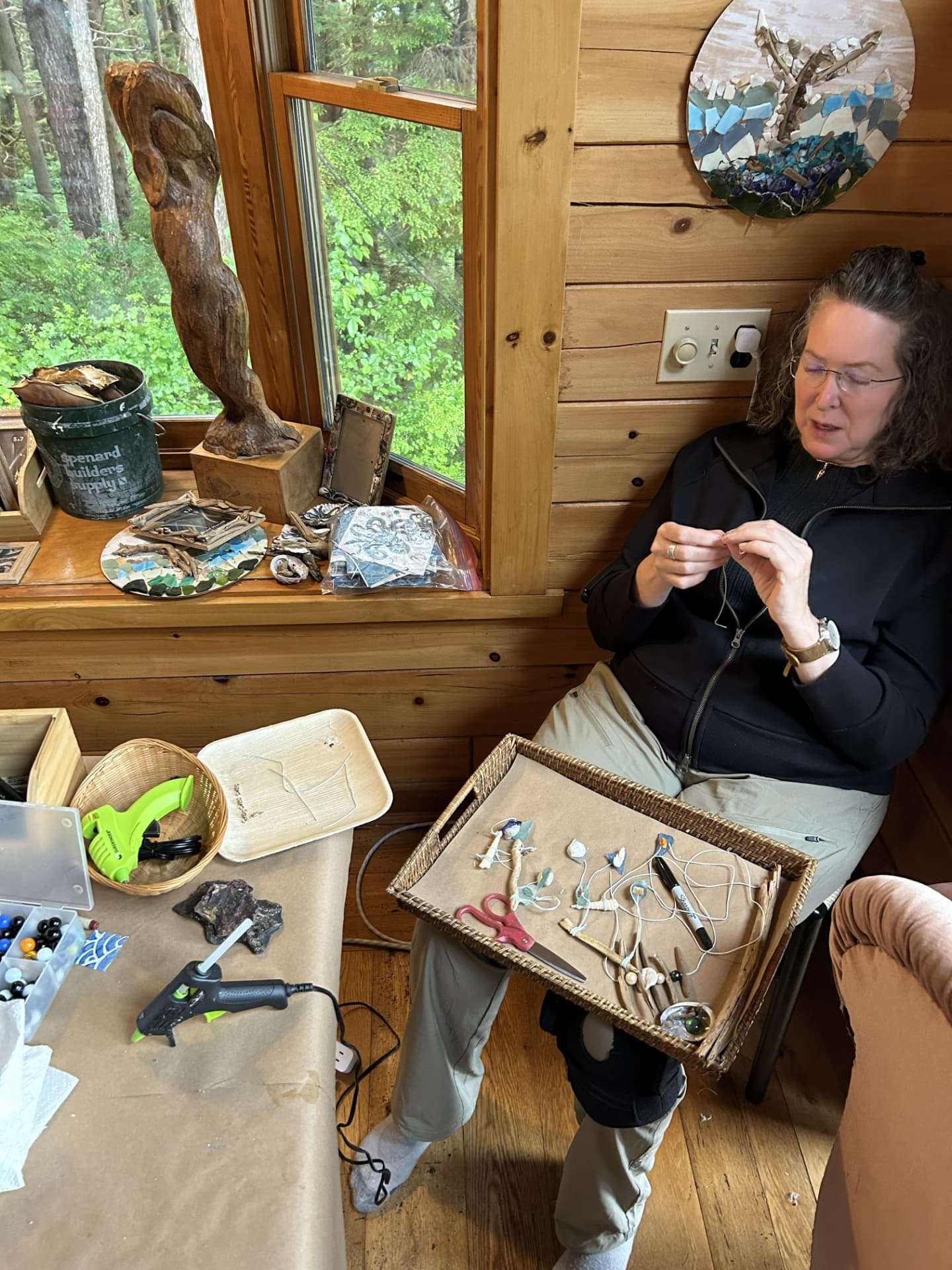 A Wild N Well guest crafting with shells and natural materials