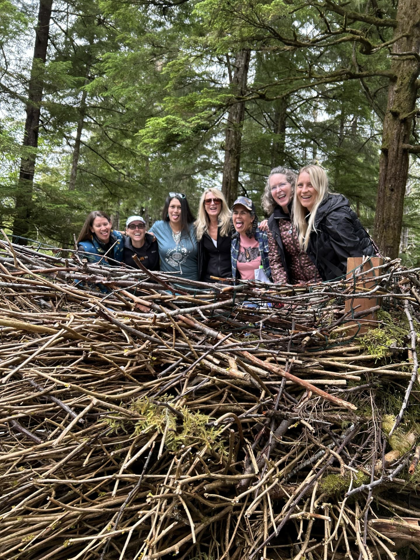 Wild N Well guests laughing together in a woodland nest