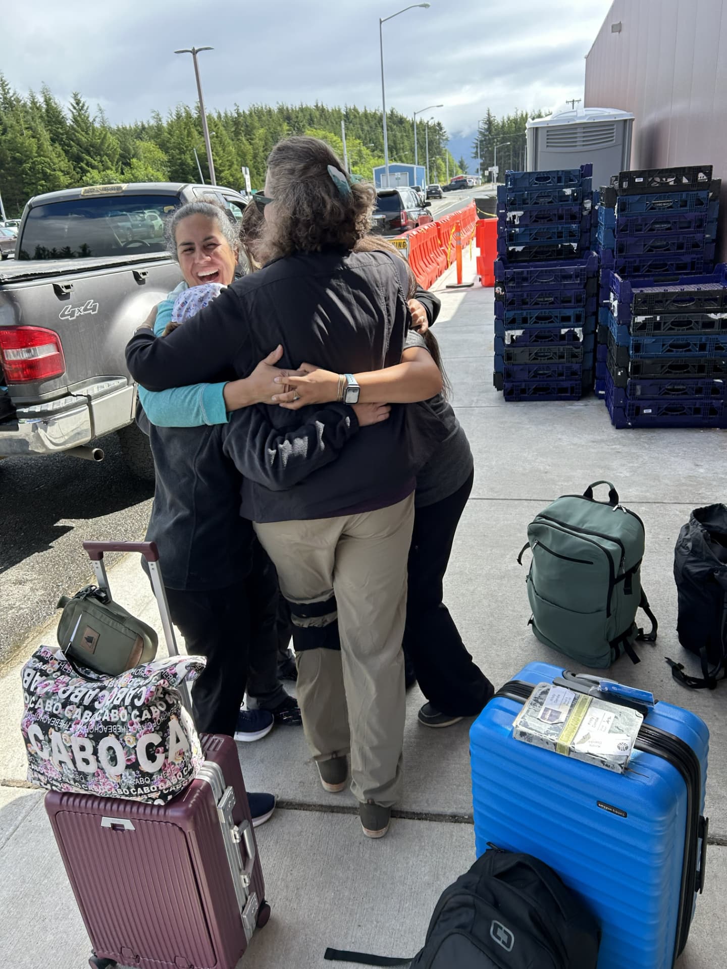 Guests embracing beside luggage at the end of the retreat