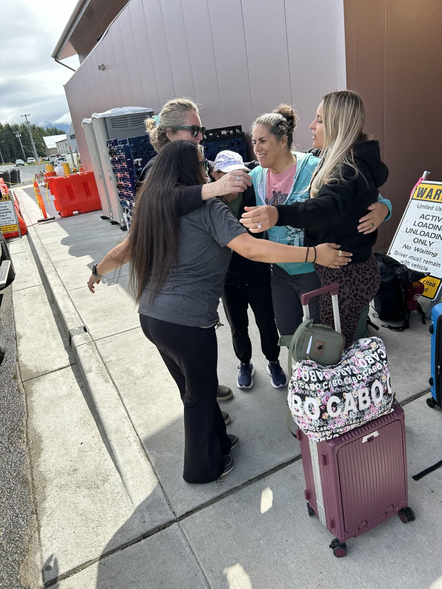 Wild N Well guests embracing as they arrive in Sitka