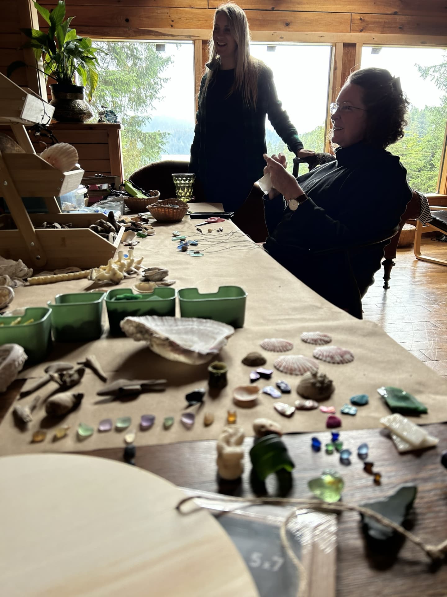 Shells, sea glass and tools spread across a Wild N Well craft table