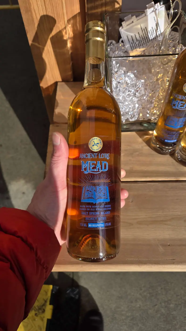 Original client photo of a full-size Ancient Lore bottle held in a hand